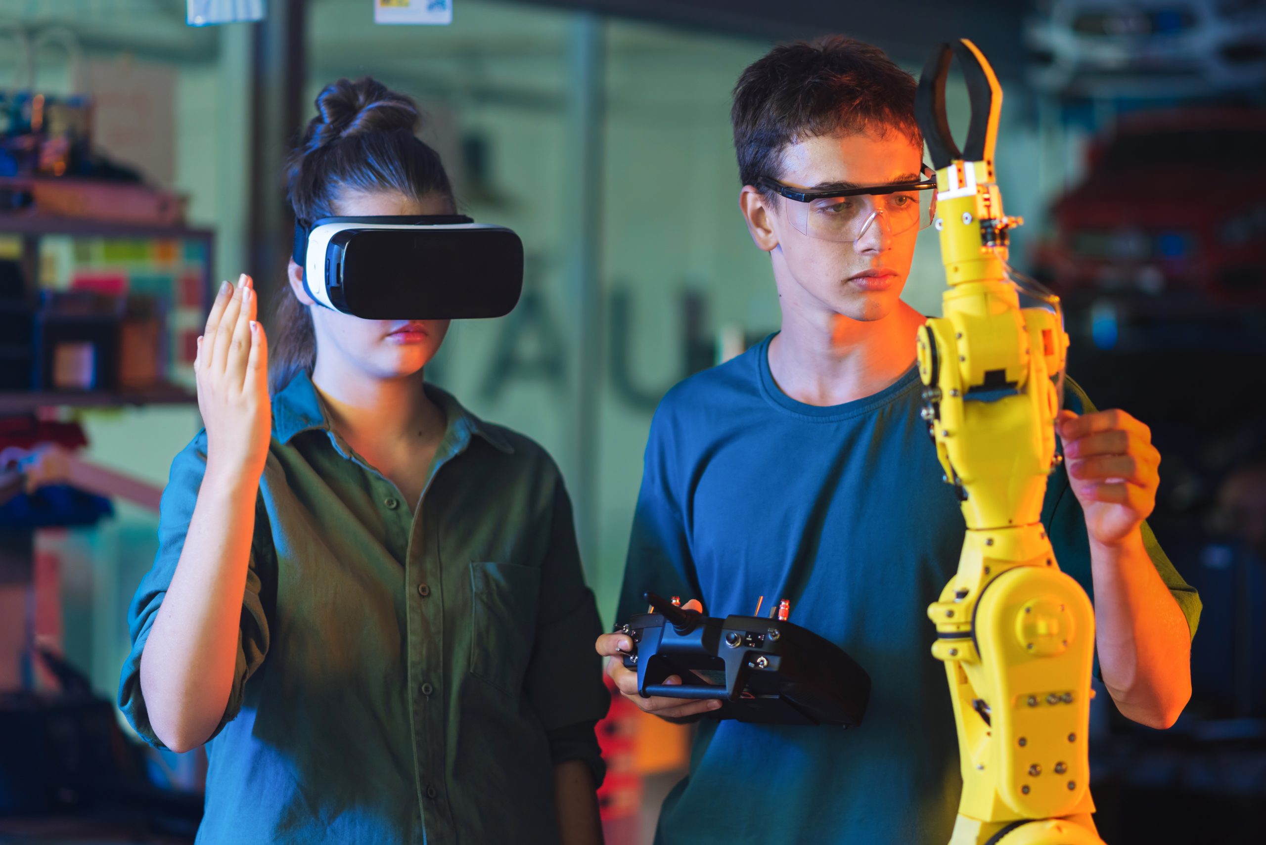 Teens remotely controlling robots in a laboratory